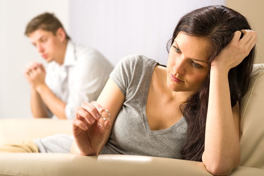 20142116 - sad wife looking at her ring after fight with husband